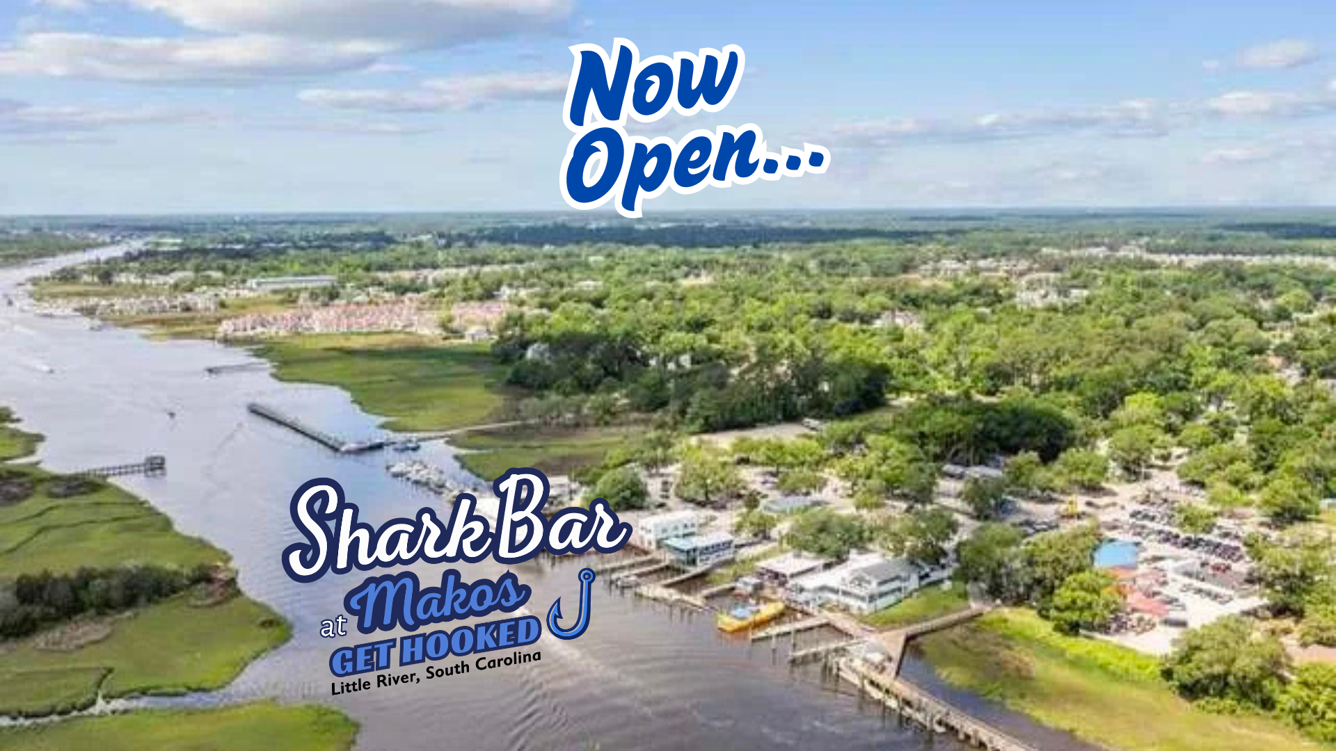 aerial image of intercoastal waterway showing the fishermans wharf area with banner talking about shark bar now open at makos on the water